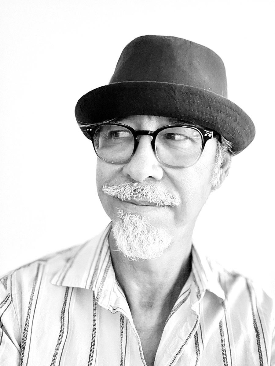 Portrait of Fernando DaRosa in a hat and glasses